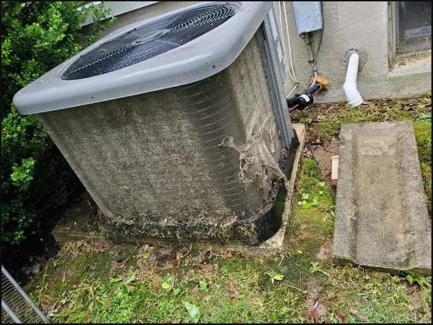 Outdoor AC unit covered in debris — before