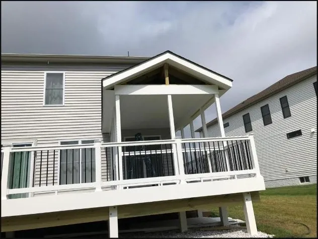 Covered deck addition with white railing