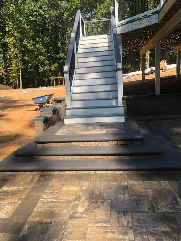 New deck stairs over a paver patio
