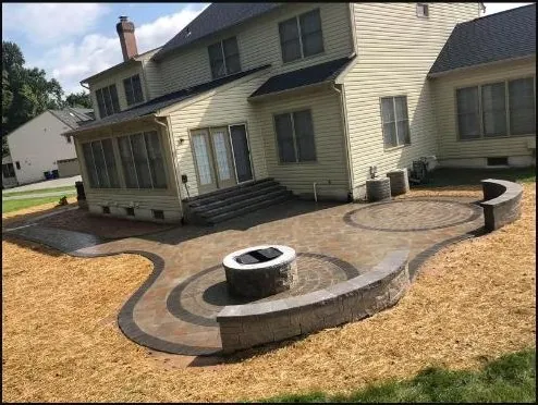 Curved paver patio with round fire pit